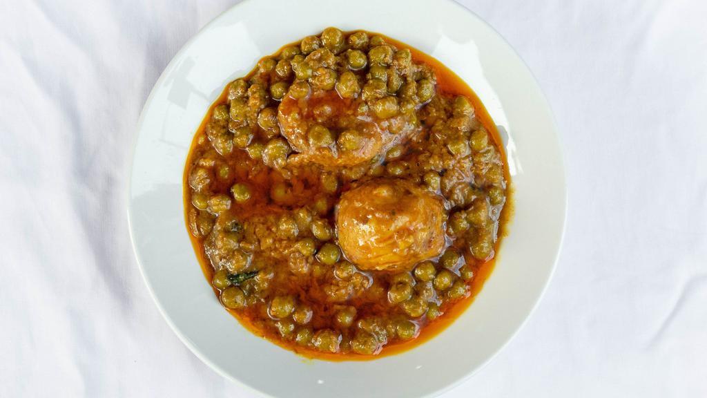Aloo Mattar · Potatoes and green peas cooked with spices and herbs.