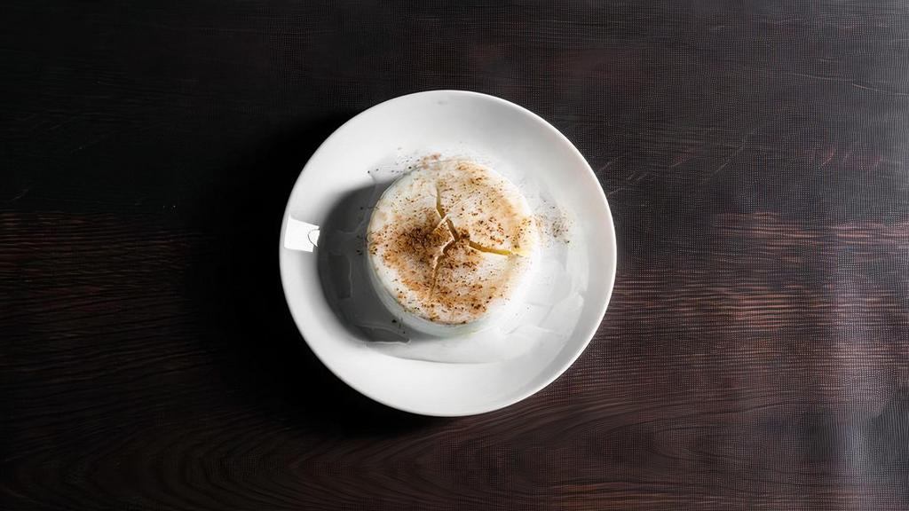 Rice Pudding · A sweet dish of rice cooked in milk and sugar, garnished with cinnamon