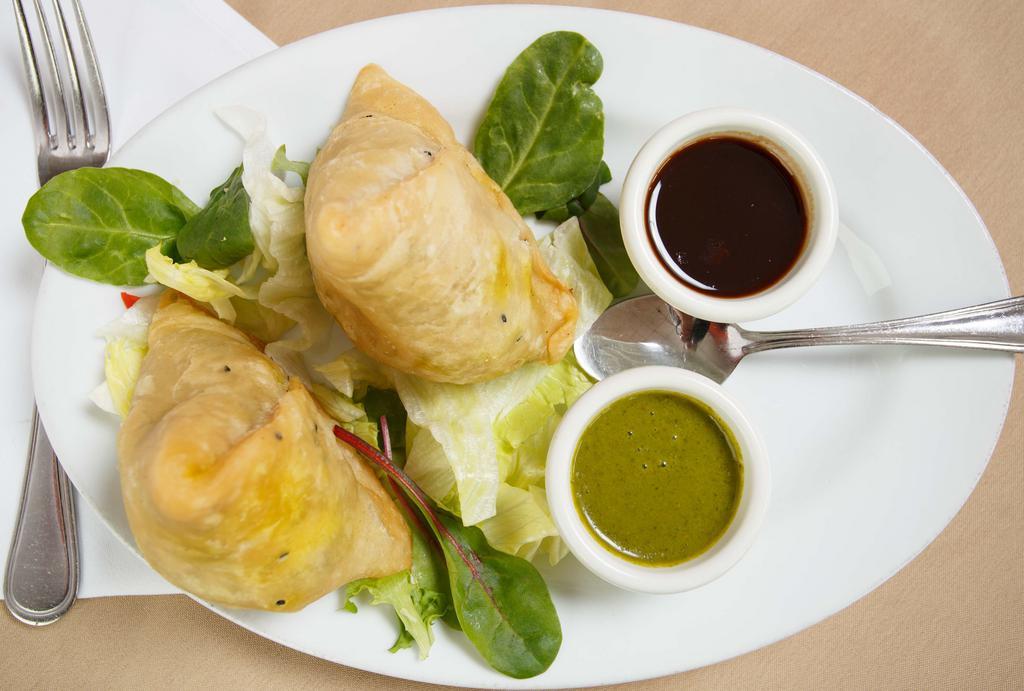 Vegetable Samosa · Pastry stuffed with potatoes and green peas with tamarind sauce.