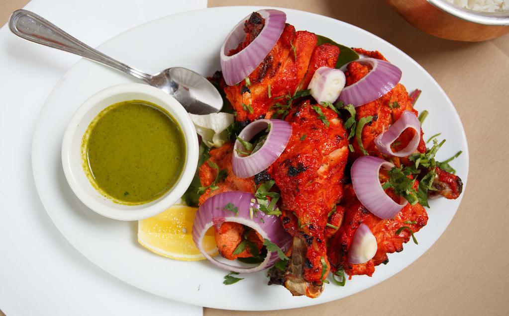 Tandoori Chicken · One half of a whole chicken on the bone marinated with ginger, garlic and cooked in the tandoor oven.