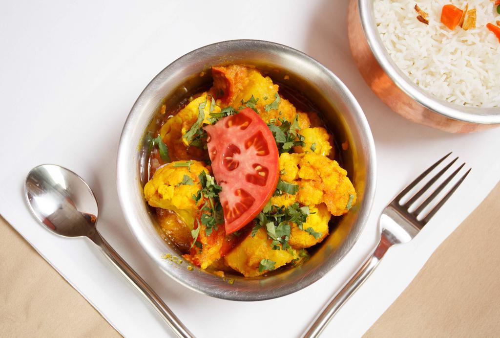 Aloo Gobi · Seasoned potatoes, tomatoes and cauliflower with a touch of an onion based sauce.