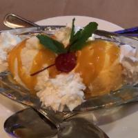 Mango Madness · Mango and coconut ice cream with topped with delicious mango syrup and whipped cream.
