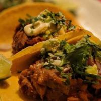 Tacos De Suadero · Bohemia-braised brisket, avocado, red onions, cilantro, tomatillo salsa and horseradish crem...