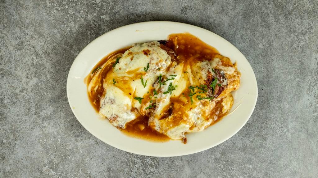 Chicken Sorrentino · Sauteed chicken breast topped with prosciutto, eggplant, and melted mozzarella in a light brown sauce.