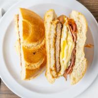 The Big Daddy · Two eggs, bacon, ham, sausage, hash browns, American cheese.