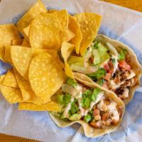 Fish Tacos · Two corn tortillas filled with grilled tilapia, pico de gallo, chipotle cream sauce and lett...