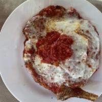 Veal Parmigiana · Veal pounded thin, topped with tomato sauce and melted mozzarella