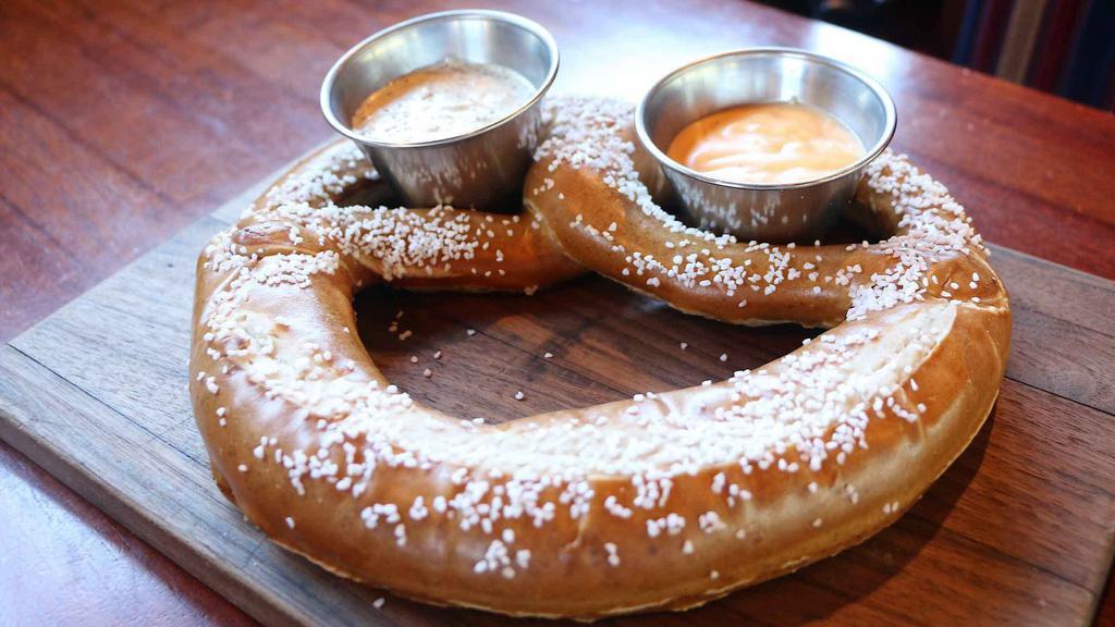 Bavarian Pretzel · Jumbo pretzel served with house-made beer cheese and creamy mustard dipping sauce.