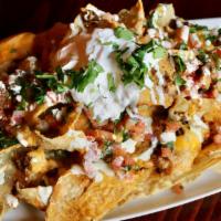 Nachos · House-made tortilla chips topped with our own nacho beef, beer cheese, cheddar and Monterey ...