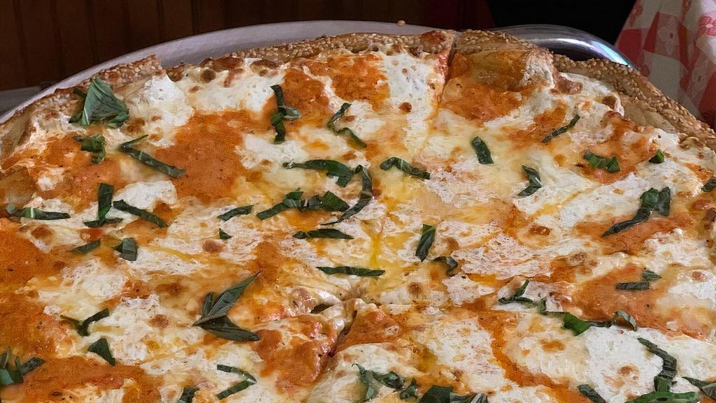 Drunken Margherita Pizza · Traditional margherita round style pizza with sliced fresh mozzarella and our
homemade vodka sauce (no prosciutto)
