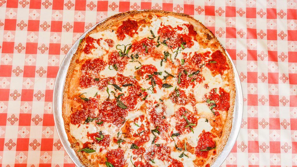 Margherita · Traditional Neapolitan style pizza topped with sliced fresh mozzarella, shredded mozzarella, marinara sauce, and basil.