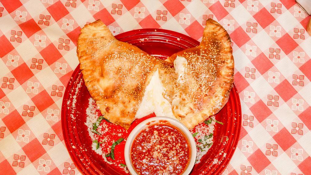 Calzone · Pizza dough pocket filled with seasoned ricotta and mozzarella cheese. Add pepperoni, meatball, or sausage fillings.