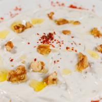 Lebne · Curd of yogurt mixed with garlic, dill, olive oil and walnuts.