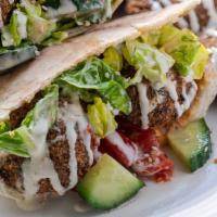 Falafel Sandwich · Served with lettuce, tomatoes, onions, hummus and sauce.