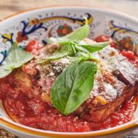 Melanzane Alla Parmigiana · Baked layers of thinly sliced eggplant, Parmigiano-Reggiano, tomato basil sauce