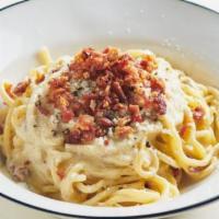 Spaghetti Alla Carbonara · Home-made spaghetti, eggs, cream, pecorino romano, parmigiano-reggiano and chopped bacon.