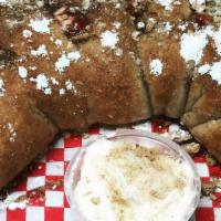 Cherry Pie Calzone · Folded dough filled with cherry pie filling, graham crackers. Topped with cinnamon butter an...