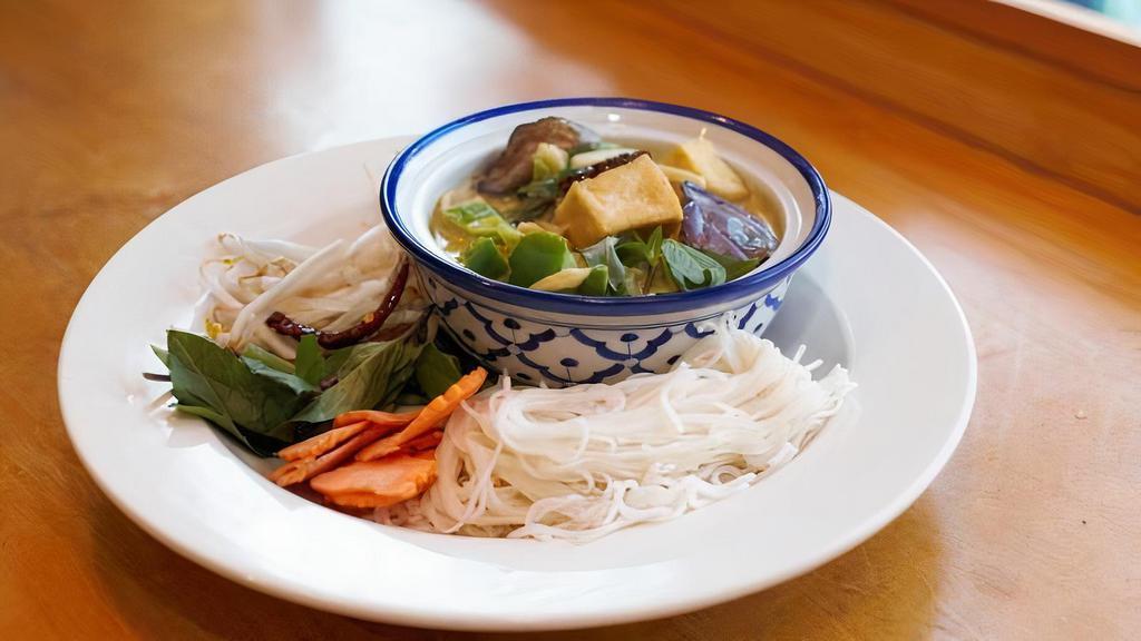 Vegan Green Curry Tofu Noodle Soup · Vegan, spicy. Rice vermicelli noodle in green curry broth with eggplant, bamboo shoot, and bell pepper topped with bean sprout and basil leaves.