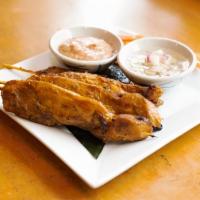 Chicken Satay · Marinated chicken on skewers served with peanut sauce and cucumber salad.