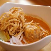 Khao Soi · Spicy. Red curry noodle soup. Egg noodle with chicken simmered in rich, creamy curry soup to...
