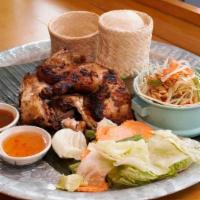 Gai Yang Khao San Kwang · Half chicken marinated with herbs and roasted to perfection served with papaya salad and sti...