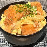 Katsudon · Pork tenderloin cutlet, egg, onion and scallion cooked with dashi soy sauce over rice.