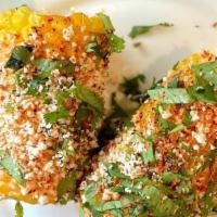 Mexican Street Corn (2Pcs) · Coated with chipotle mayo and fresh cheese as well as a bit of Tajin and hot sauce sprinkled...