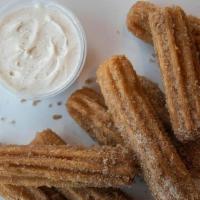 Churros (8 Pc) · 9 pieces of churros with our cinnamon icing dip.
