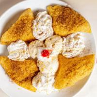Sopapillas · Mexican pastry topped with honey, vanilla ice cream, cinnamon, and whipped cream.