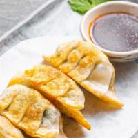 Vegetable Pan Fried Dumpling · Pan fried dumplings filled with sweet corn, carrot, green pea, and chives.