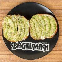 Avocado Bagel Toast · Toasted whole wheat bagel with cream cheese,  avocado slices, mashed avocado, and topped wit...