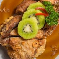 Duck Tamarind · Crispy boneless half duck with thai eggplants, kiwi and tamarind sauce.