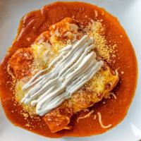 Enchiladas En Salsa Roja · 3 soft corn tortillas with filling of your choice, topped with melted  cheese, onions and so...