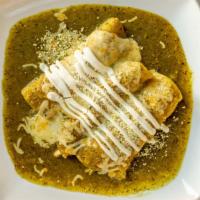 Enchiladas Suiza · 3 soft corn tortillas with filling of your choice, topped with melted cheese, onions and sou...