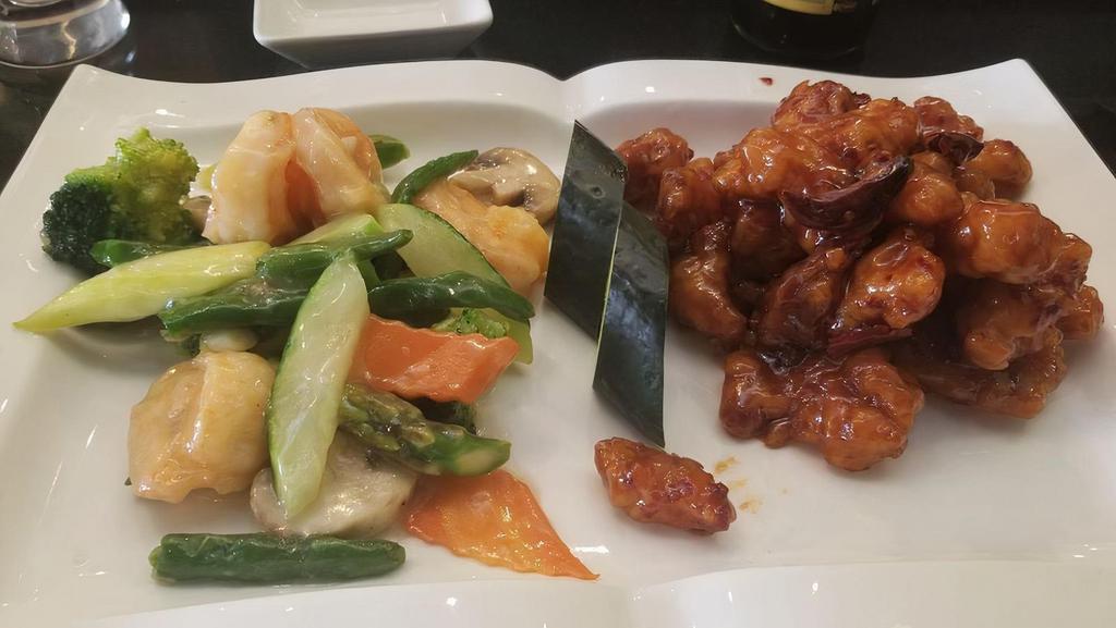 Dragon & Phoenix · Combination of general tso's chicken on the side and jumbo shrimp, mixed vegetables with white sauce on the others
