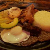 Traditional Plate With Grilled Steak · Served with rice, beans with pork and choice of an optional side.