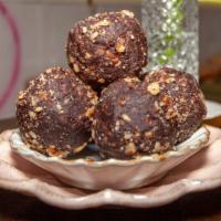 Peanut Butter & Dark Chocolate Energy Balls · Made with Chopped Dates, Organic Peanut Butter, Cocoa Powder, Almond Milk, Walnuts & Love!