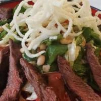 Asian Beef Salad · Soy & ginger marinated sliced steak, white beans, tomatoes, peppers, toasted cashews, kung p...