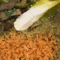 Steak In Green Sauce · Served with rice, beans, and tortillas.