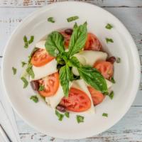 Caprese · Fresh mozzarella cheese, tomatoes, basil and drizzled with olive oil.