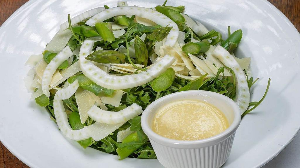 Arugula Salad · Arugula, shaved fennel, shaved parmesan cheese and asparagus with a lemon vinaigrette.