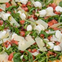 Arugula Pizza · Arugula, chopped tomatoes, onions, fresh basil, parmesan cheese and fresh mozzarella cheese.