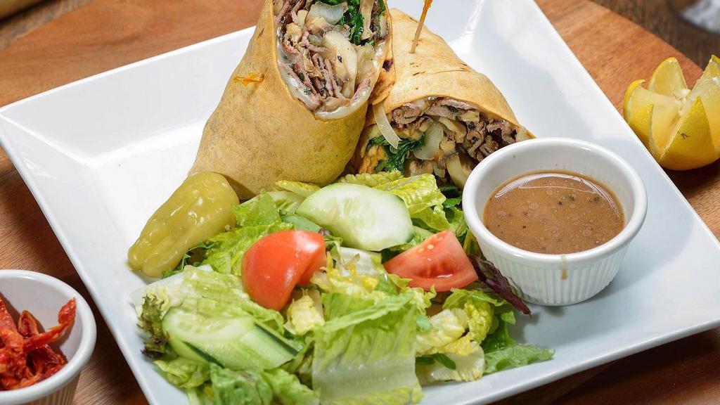 Rib Eye Steak Wrap · Rib eye steak, caramelized onions, mushrooms, arugula and provolone cheese. Served with your choice of wrap. Includes side house salad.