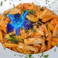 Penne Primavera And Chicken · Mixed vegetables and chicken in a light pink sauce.