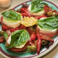 Insalata Caprese Antipasto · Fresh mozzarella, tomatoes, basil, sun-dried tomatoes, olives, roasted red peppers, marinate...