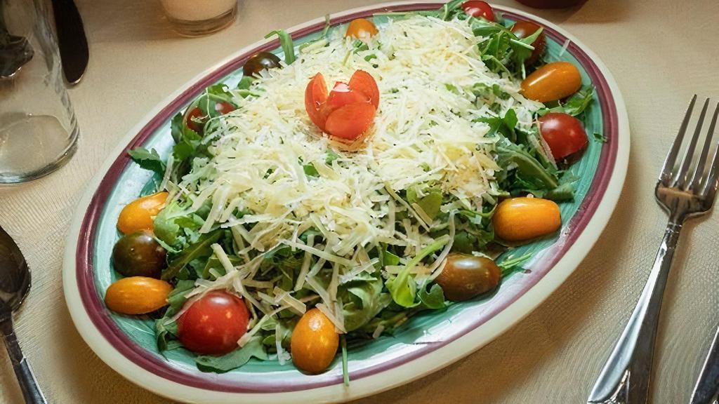 Baby Arugula Salad · With shaved parmigiano cheese and cherry tomatoes.