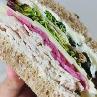 Turkey And Comte Sandwich · Sliced turkey breast with sliced Marcel Petit Comte cheese, pickled red onion, dressed red l...