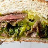 Warm Roast Beef Sandwich · House-made roast beef w/ salmoriglio, pickled banana peppers and melted provolone. On a toas...