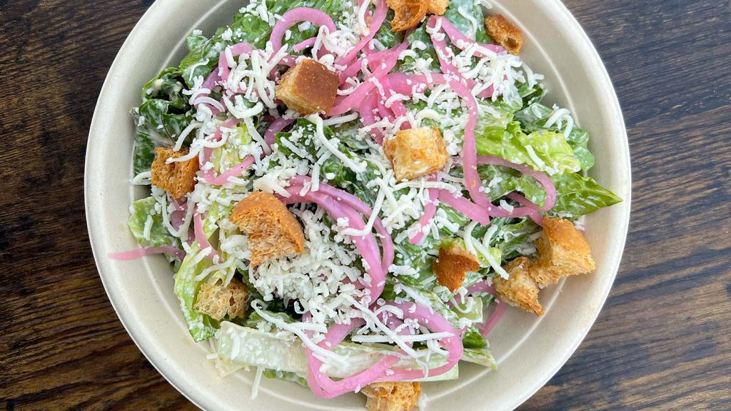 Vegetarian Caesar Salad · A vegetarian caesar salad with crispy fresh romaine, red pickled onions, shredded provolone, croutons and a gluten-free, vegetarian dressing. The dressing is specially made to be vegetarian with hints of smoked dulse, a vitamin-filled seaweed. Can be served without croutons to be fully gluten-free.