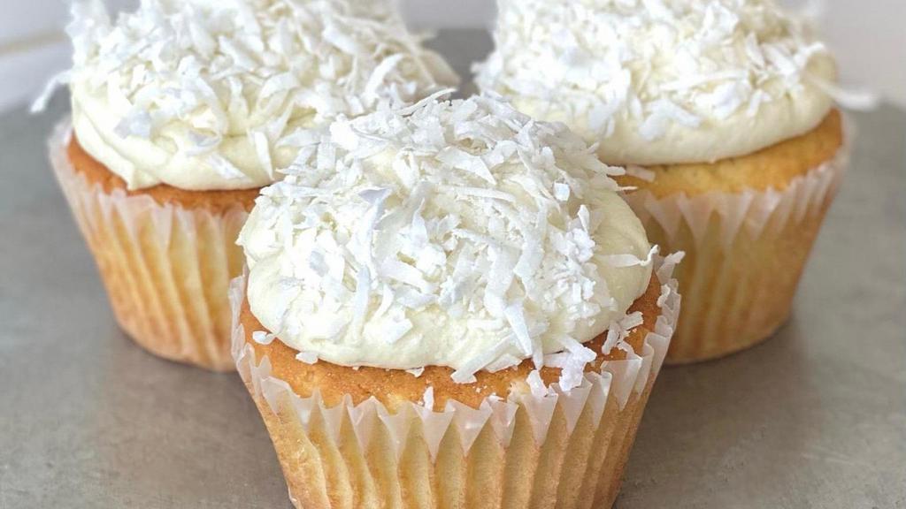 Coconut Cupcake · Larder-made & filled with coconut custard, topped off with coconut cream cheese frosting. 

Contains Nuts